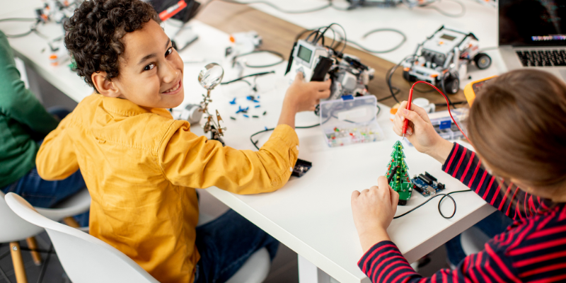 two kids creating a robot