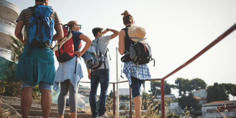 A group of college students looking at a building